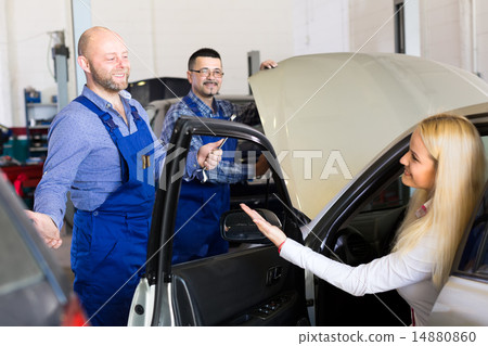 Woman taking her car for service Woman taking her car for service 14880860