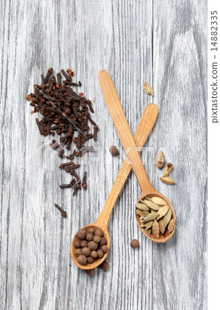 Nutmeg, clove and allspice in old spoon on wood 14882335