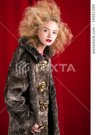 Beautiful blond woman in a fur 14891389