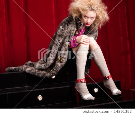 Beautiful blond woman in a fur 14891392