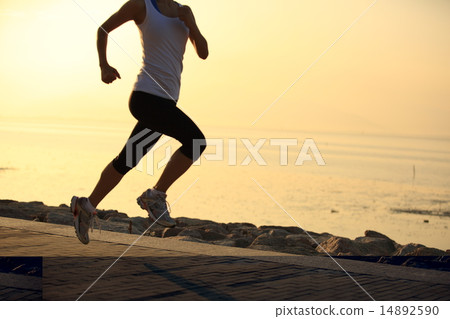 Runner athlete running at seaside  14892590