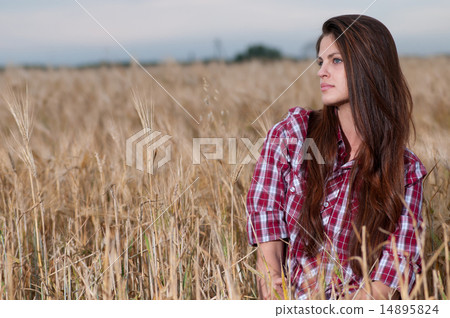 Beautiful cowboy woman posing in field 14895824
