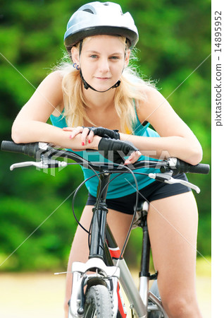 Young smiling woman on bike 14895952