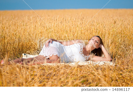 Beautiful woman posing in wheat field. Picnic. Beautiful woman posing in wheat field. Picnic. 14896117