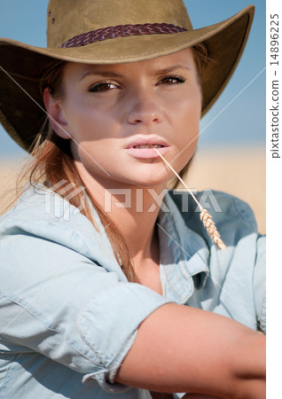 Cowboy woman in country wheat field 14896225