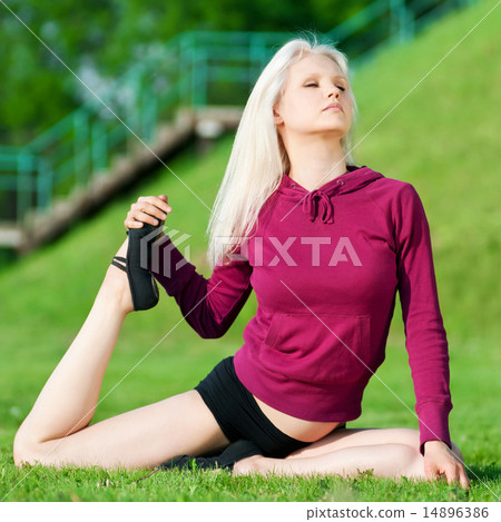 Beautiful woman doing yoga stretching exercise Beautiful woman doing yoga stretching exercise 14896386