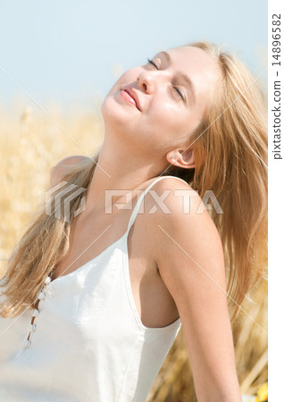 Happy woman on picnic in wheat field Happy woman on picnic in wheat field 14896582