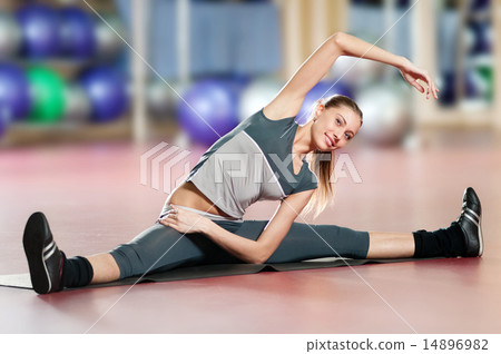Woman doing stretching fitness exercise at sport gym. Yoga 14896982