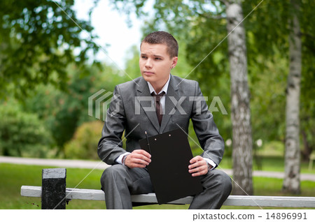 business man working with papers at park. Student 14896991