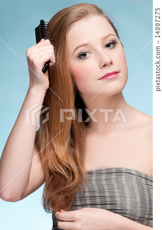 Close up portrait of young beautiful woman with comb Close up portrait of young beautiful woman with comb 14897275