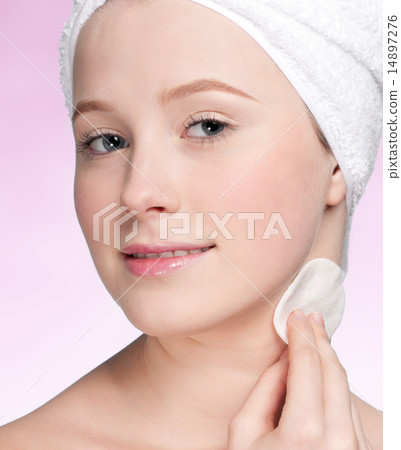 Close-up face of young woman applying sponge Close-up face of young woman applying sponge 14897276