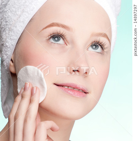 Close-up face of young woman applying sponge 14897297