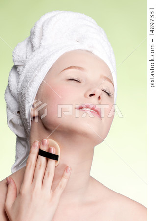 Close-up face of young woman applying sponge 14897331