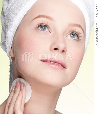Close-up face of young woman applying sponge Close-up face of young woman applying sponge 14897332