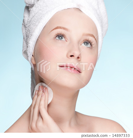 Close-up face of young woman applying sponge Close-up face of young woman applying sponge 14897333