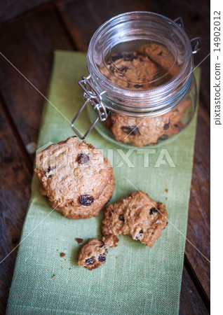 Oatmeal cookies with raisins on wooden background,vintage 14902012