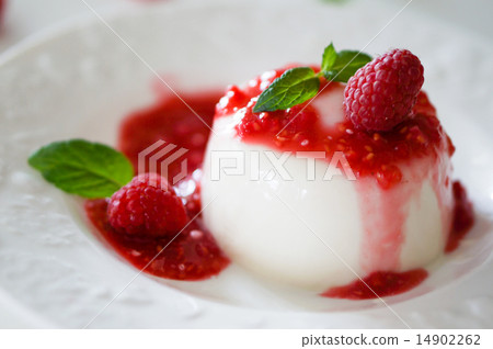 Delicious italian dessert panna cotta with raspberry sauce and m 14902262