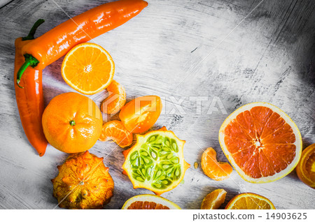 Orange fruits and vegetables on rustic background Orange fruits and vegetables on rustic background 14903625