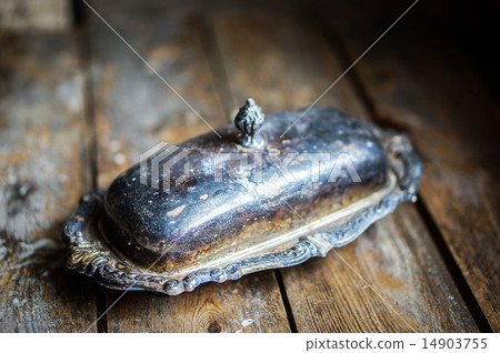 Vintage silver butter dish on wooden background Vintage silver butter dish on wooden background 14903755