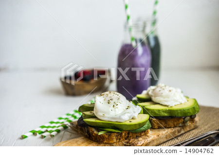 Healthy sandwich with avocado and poached eggs Healthy sandwich with avocado and poached eggs 14904762