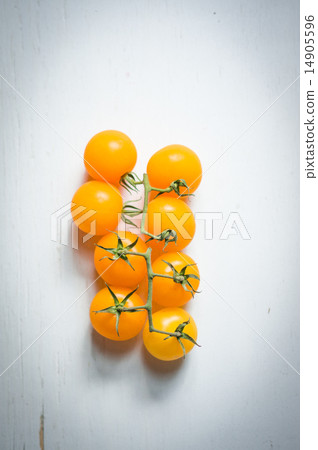 Yellow tomatoes on the vine on wooden background 14905596