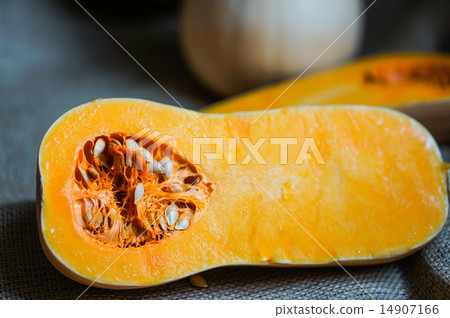 Uncooked sliced butternut squash on wooden background Uncooked sliced butternut squash on wooden background 14907166