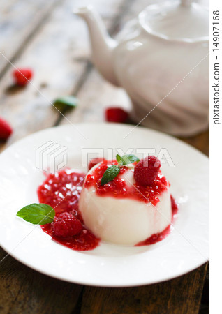 Delicious italian dessert panna cotta with raspberry sauce and m 14907168