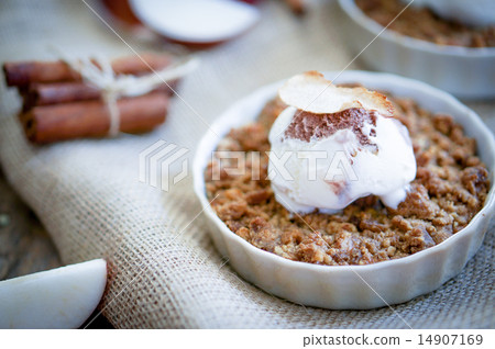 Apple crumble dessert with cinnamon and vanilla ice -cream on wo 14907169