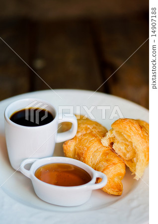 Tasty breakfast:coffee with croissants and jam on wooden backgro Tasty breakfast:coffee with croissants and jam on wooden backgro 14907188