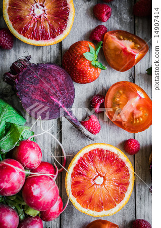 Stock Photo: Red fruits and vegetables on wooden background