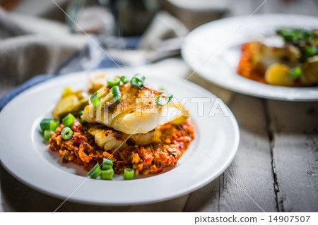 Roasted hake with romesco sauce and onion on wooden background 14907507