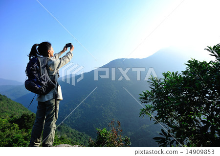 woman hiker taking photo with smart phone woman hiker taking photo with smart phone 14909853