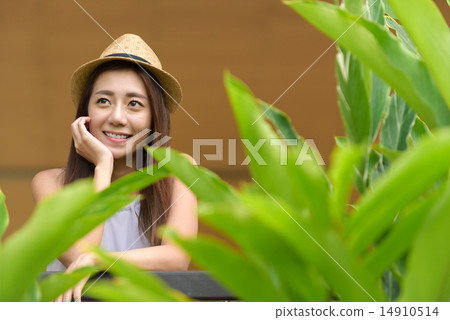 Young Chinese woman putting one hand on her face 14910514