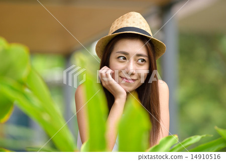 Young Chinese woman putting one hand on her face Young Chinese woman putting one hand on her face 14910516