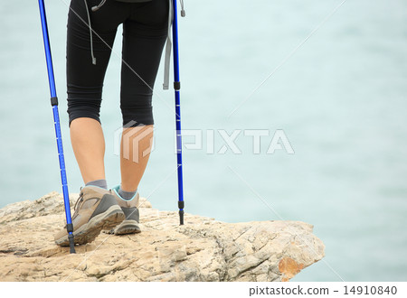 woman hiker hiking stand on seaside rock woman hiker hiking stand on seaside rock 14910840