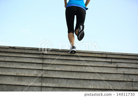 sports woman legs running up on stone stairs 14911730