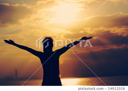 woman open arms under the sunrise at seaside 14912016