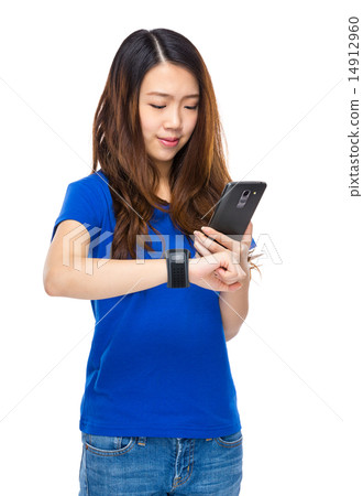 Woman use smartphone to connect with wearable watch Woman use smartphone to connect with wearable watch 14912960