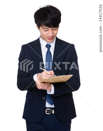 Businessman write on clipboard Businessman write on clipboard 14917036