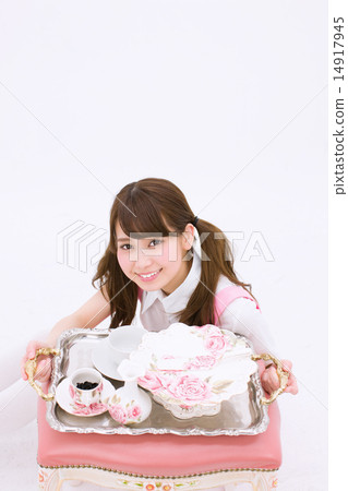 A young maid with a smile showing a tray with cute dishes A young maid with a smile showing a tray with cute dishes 14917945