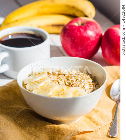oatmeal with bananas, apples and a cup of coffee oatmeal with bananas, apples and a cup of coffee 14922084