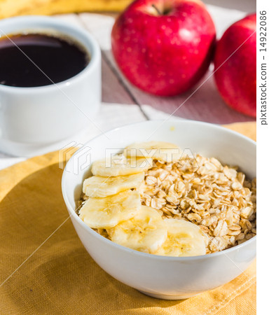 oatmeal with bananas, apples and a cup of coffee oatmeal with bananas, apples and a cup of coffee 14922086