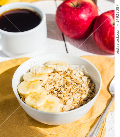 oatmeal with bananas, apples and a cup of coffee 14922087