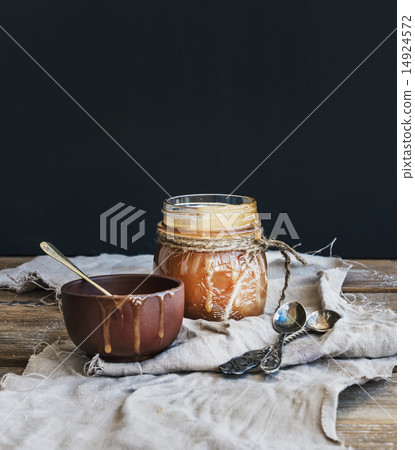 Salted caramel sauce in a rustic glass jar 14924572
