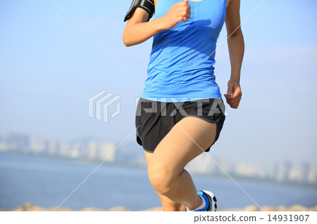 Runner athlete running at seaside city 14931907