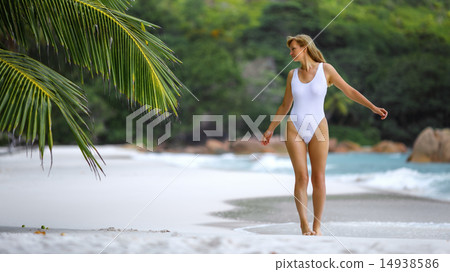 Woman in a white bathing suit on a tropical beach. Woman in a white bathing suit on a tropical beach. 14938586
