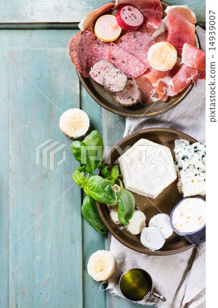 Plates of cheese and sausage 14939007