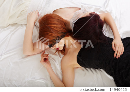 Sexual girlfriends hugging while lying in bed Sexual girlfriends hugging while lying in bed 14940423