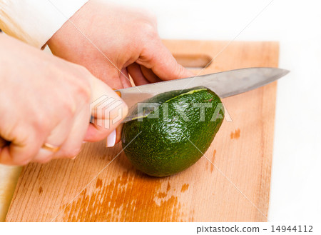chef cuts the avocado closeup 14944112