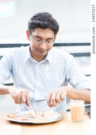 Handsome man eating food at cafeteria. 14955837